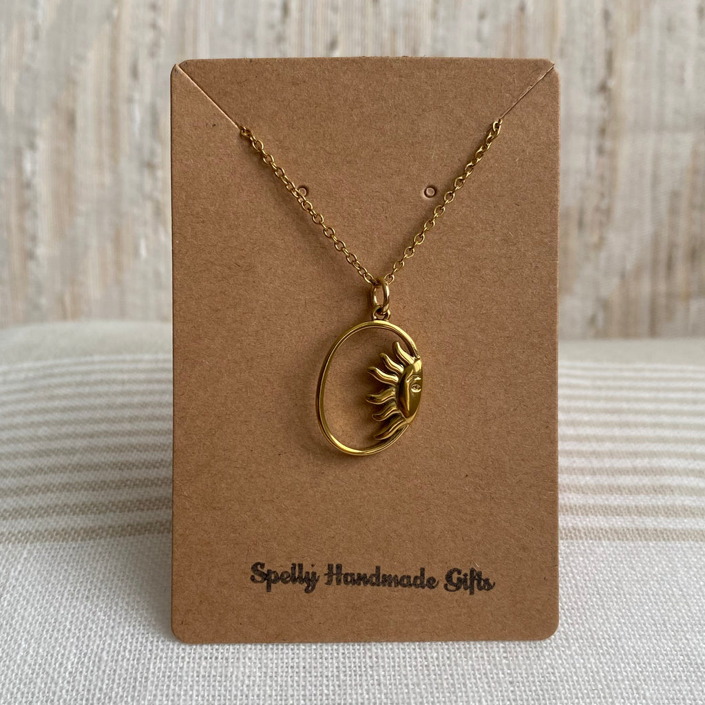 Gold Peaking Sun in Oval Pendant Necklace