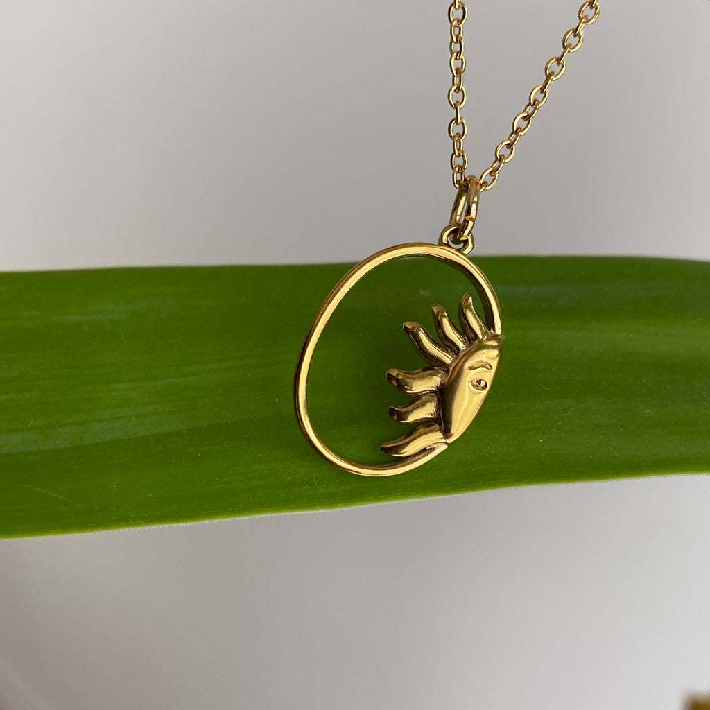 Gold Peaking Sun in Oval Pendant Necklace