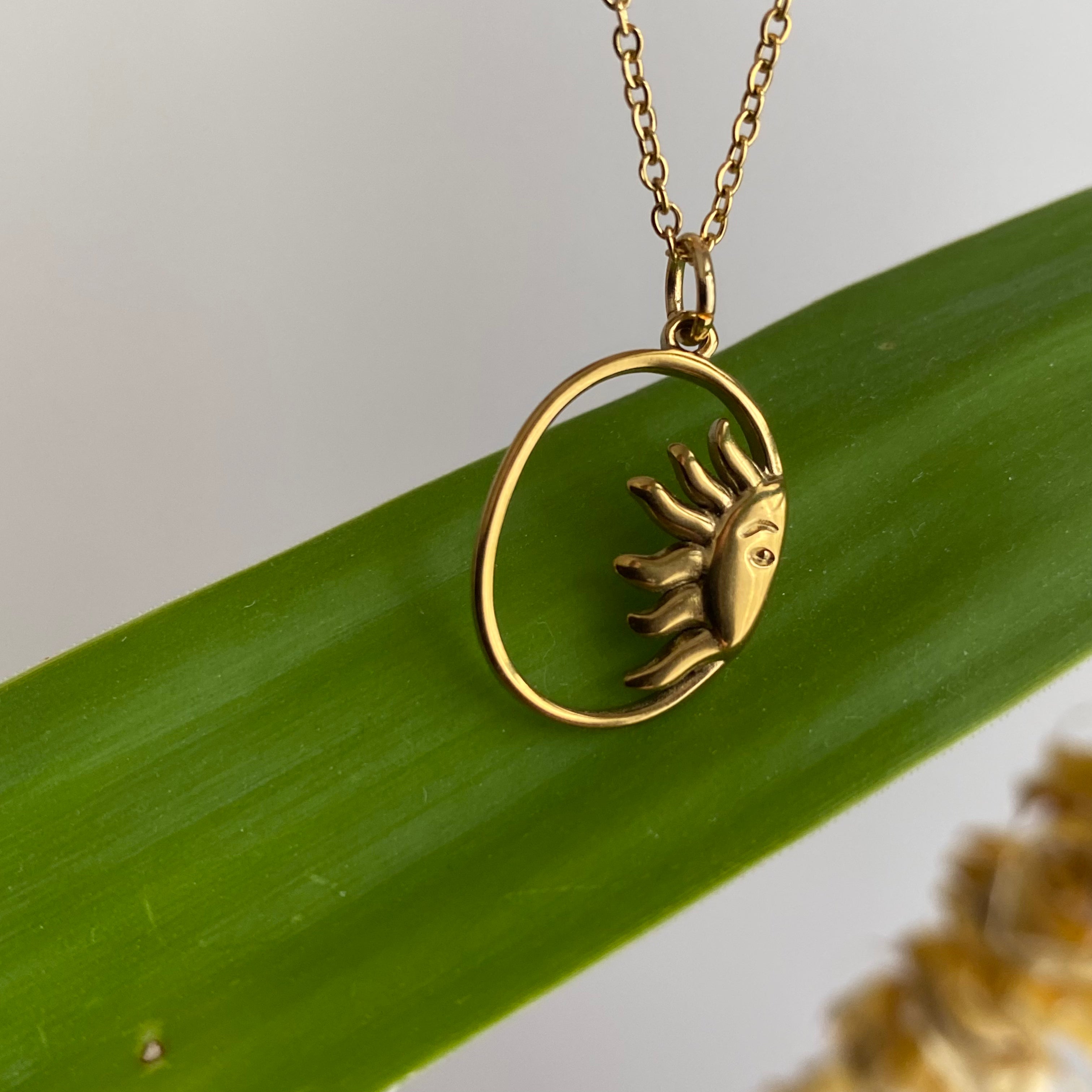 Gold Peaking Sun in Oval Pendant Necklace