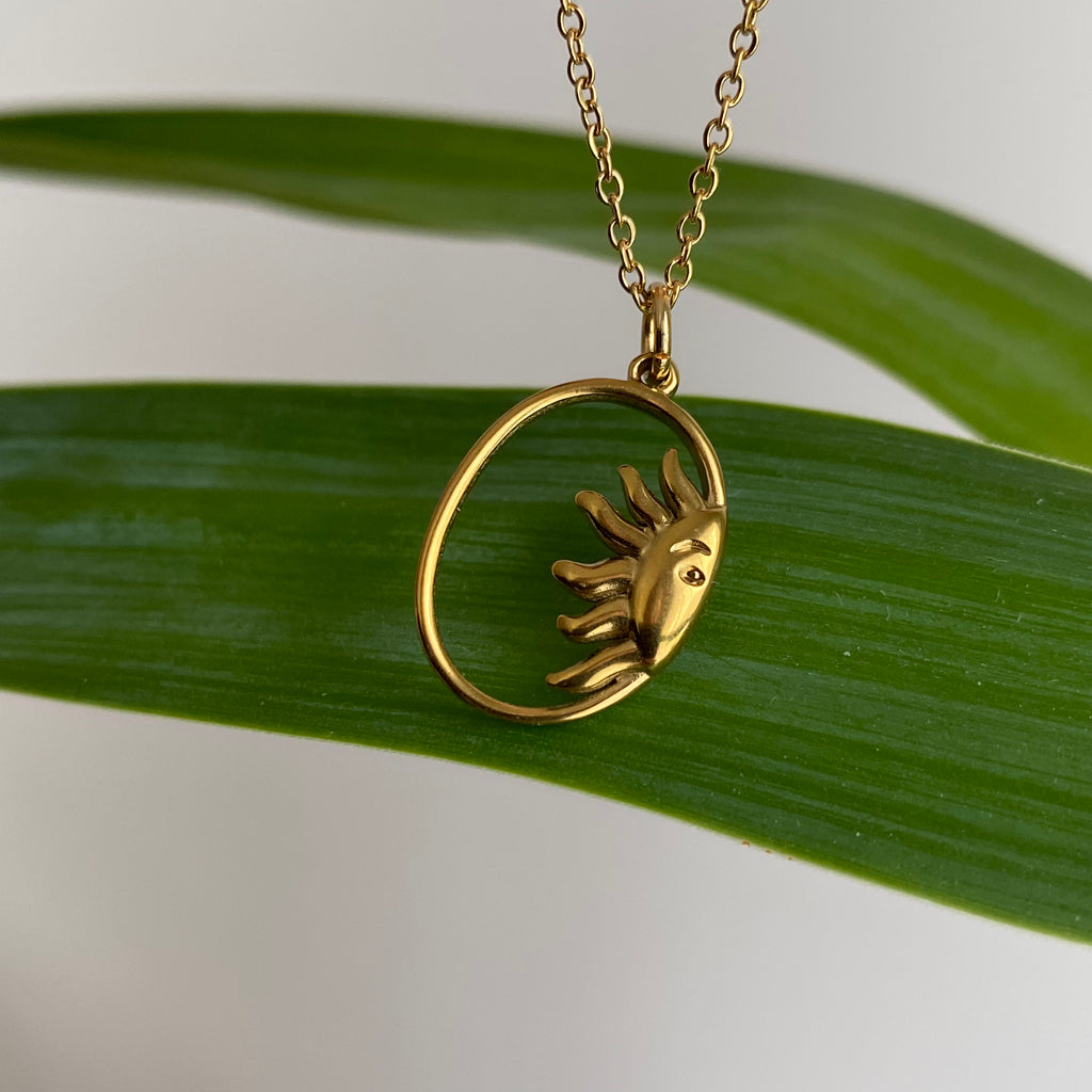 Gold Peaking Sun in Oval Pendant Necklace