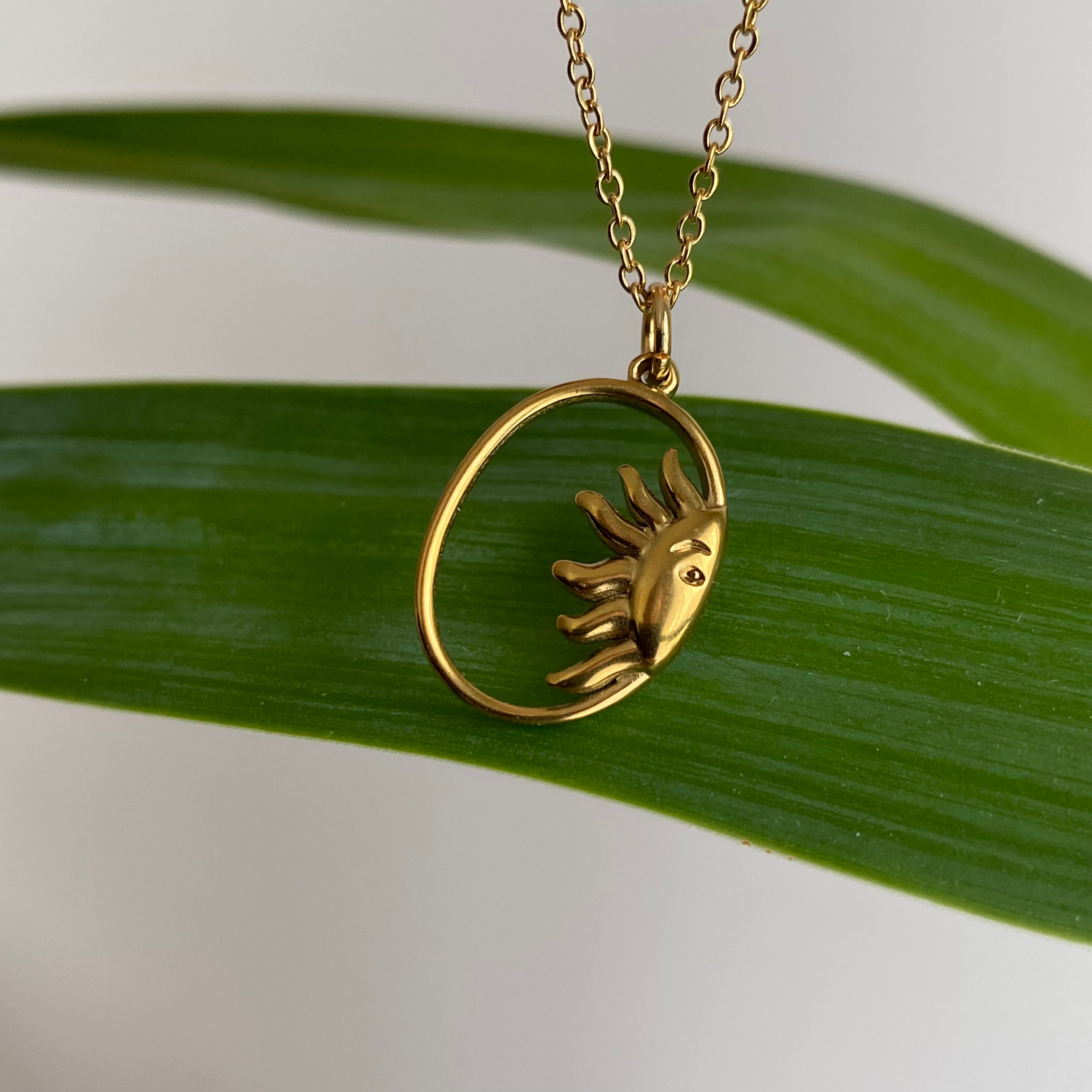Gold Peaking Sun in Oval Pendant Necklace