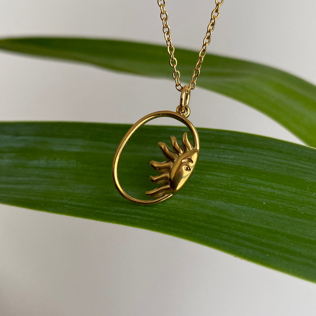 Gold Peaking Sun in Oval Pendant Necklace