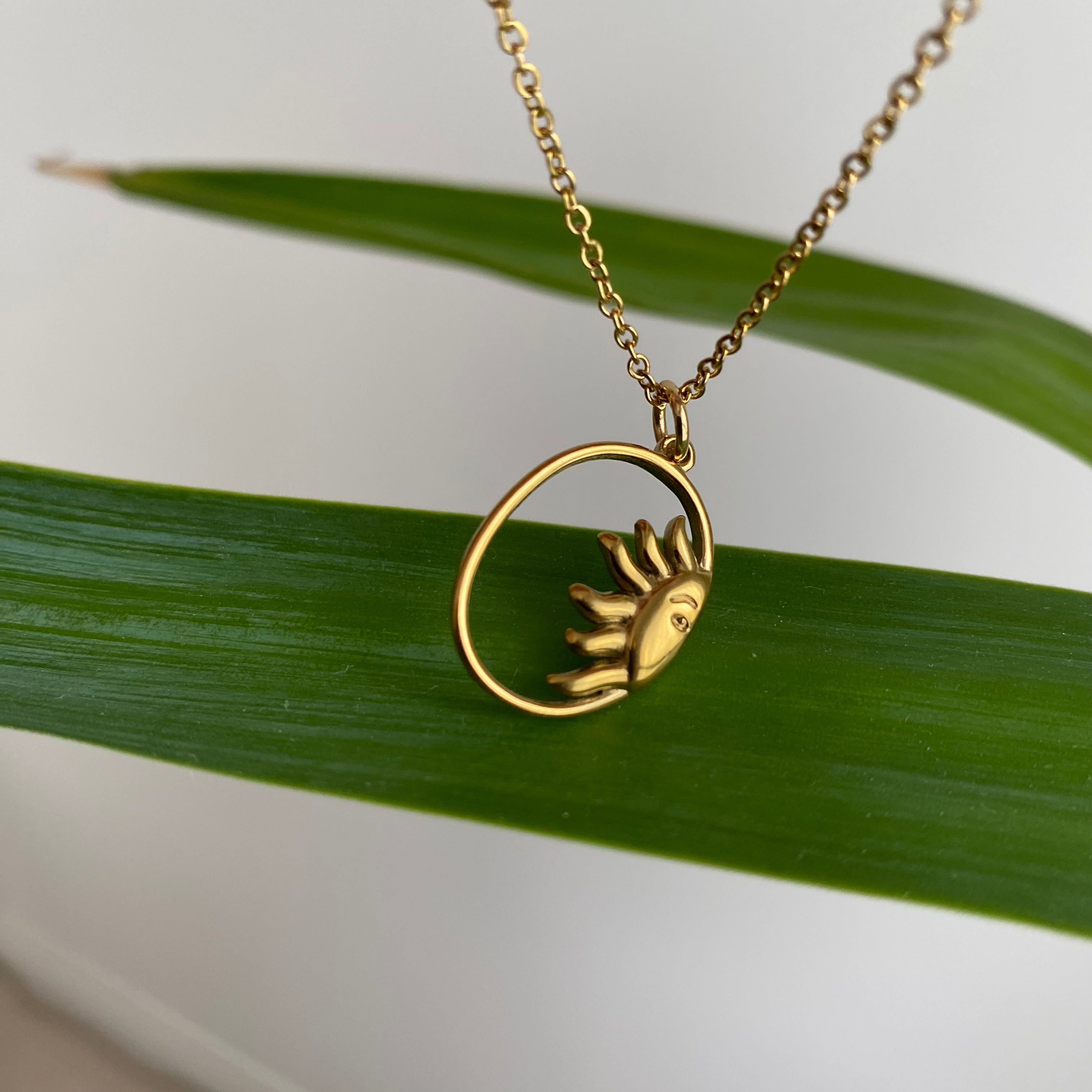 Gold Peaking Sun in Oval Pendant Necklace