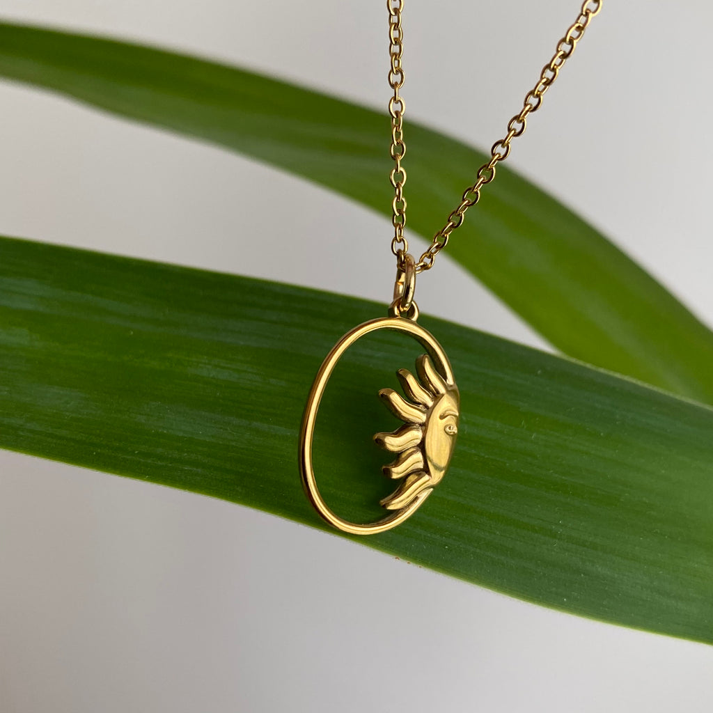 Gold Peaking Sun in Oval Pendant Necklace