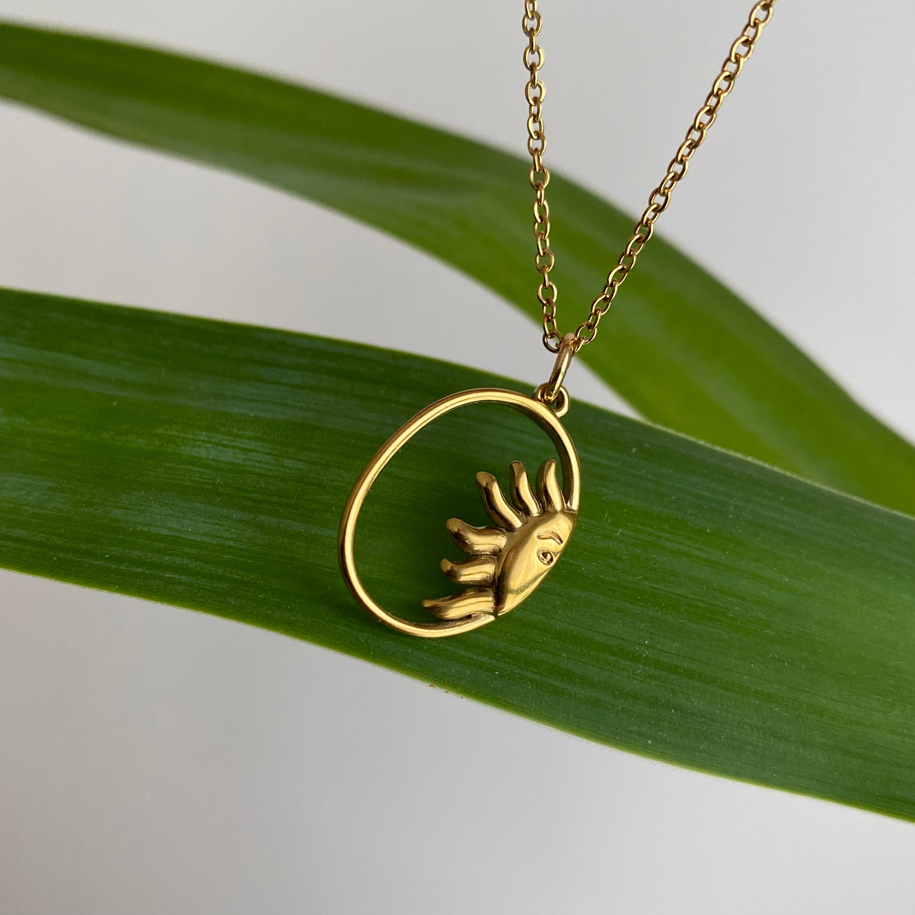 Gold Peaking Sun in Oval Pendant Necklace