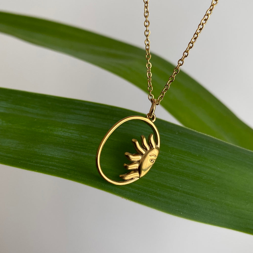 Gold Peaking Sun in Oval Pendant Necklace