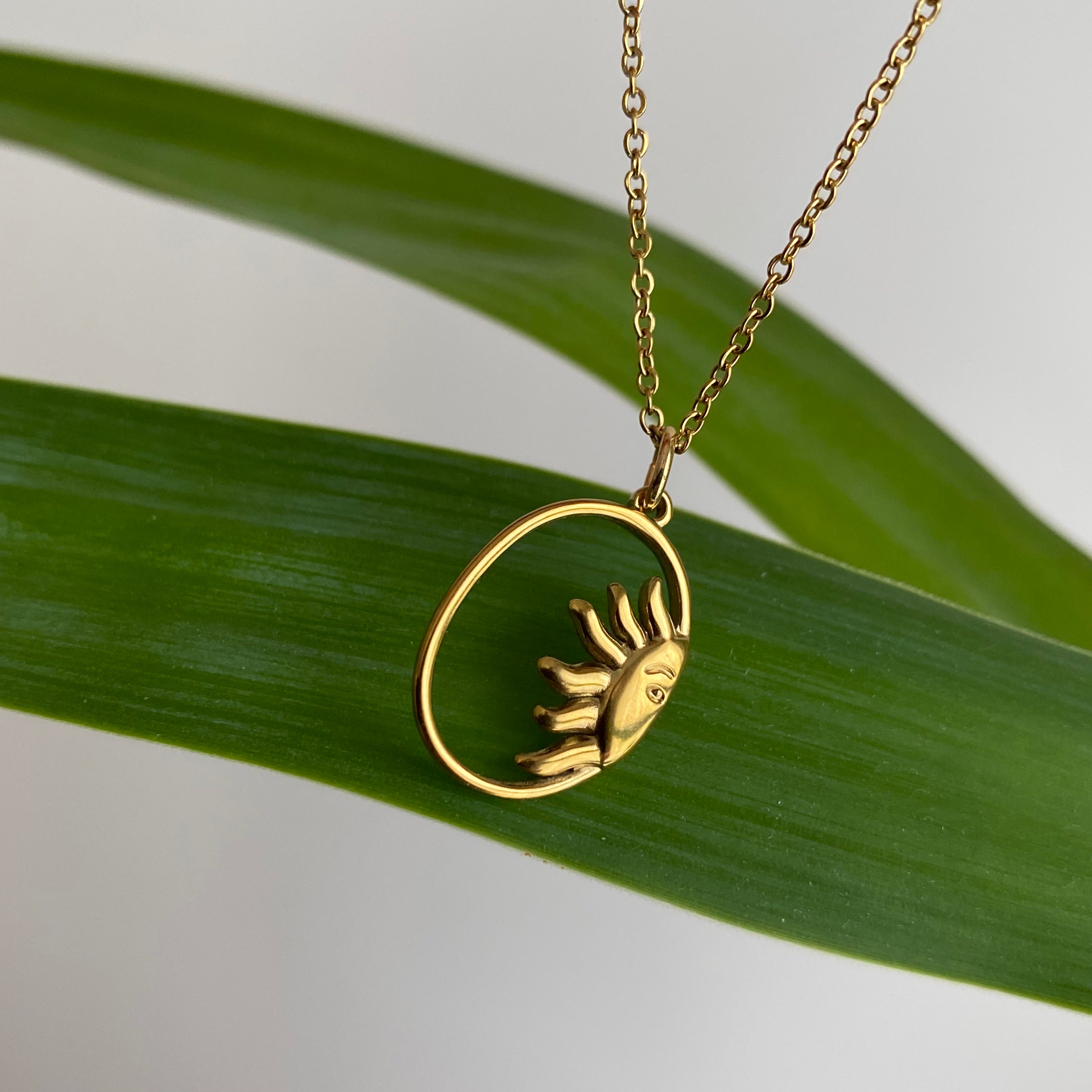 Gold Peaking Sun in Oval Pendant Necklace