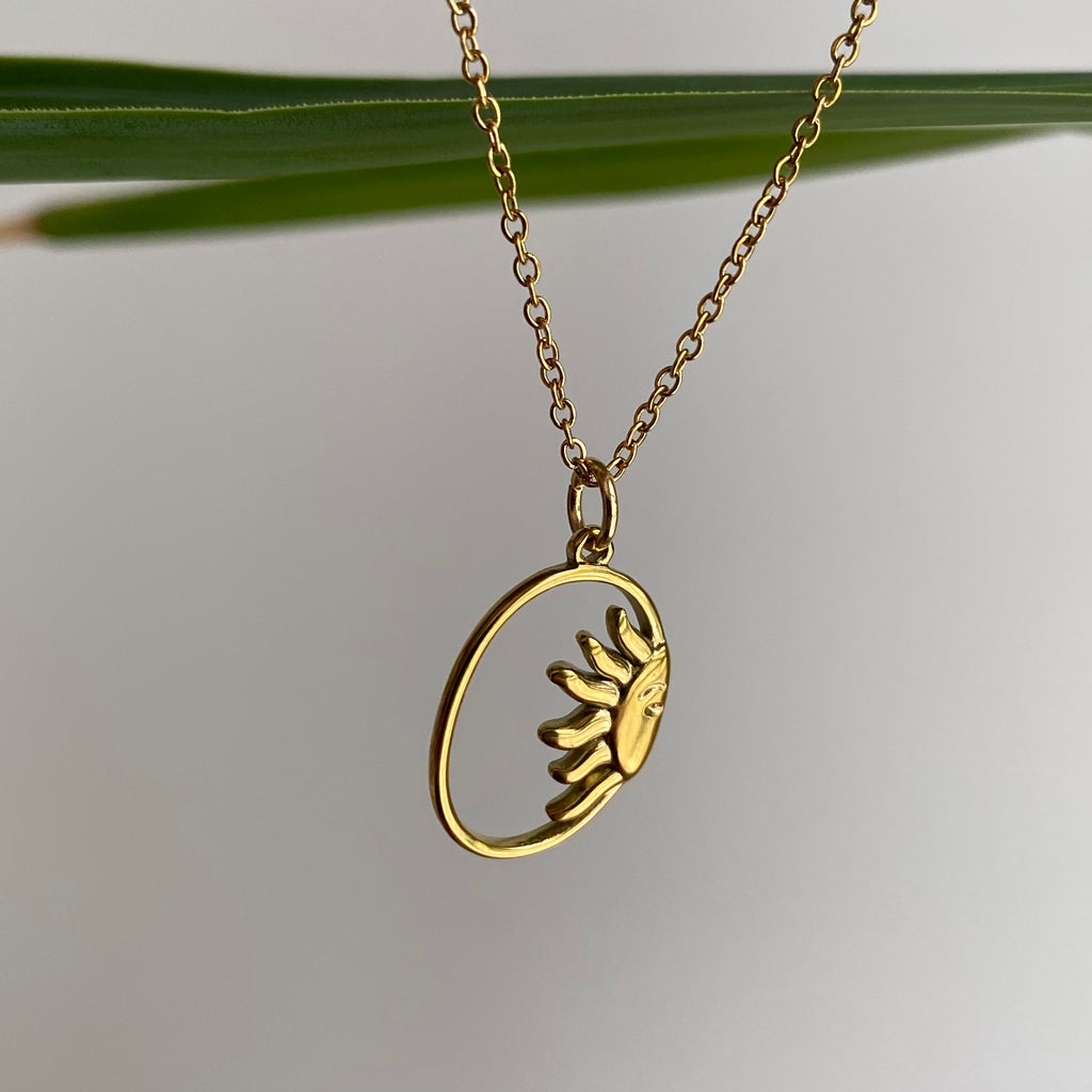 Gold Peaking Sun in Oval Pendant Necklace