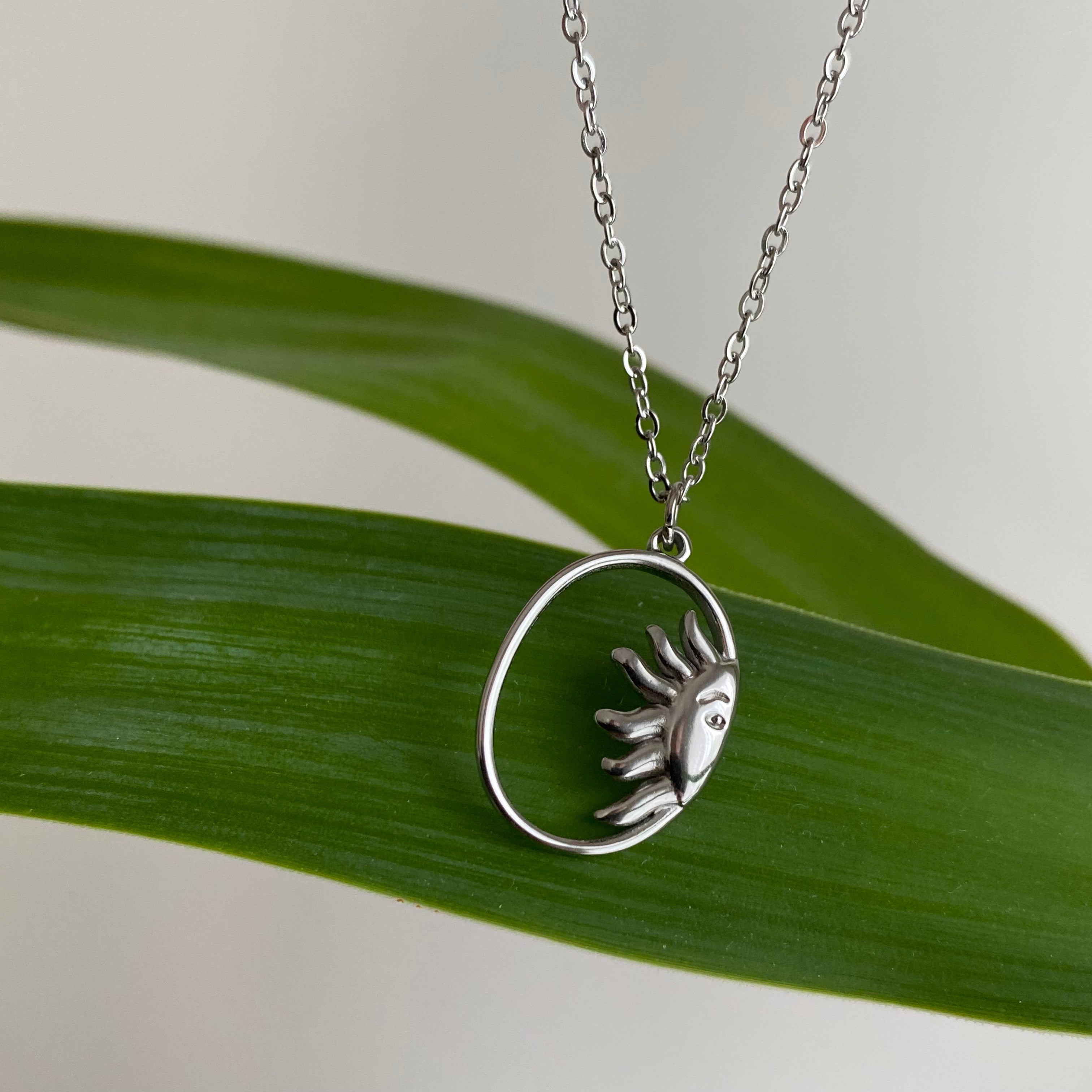 Silver Peaking Sun in Oval Pendant Necklace