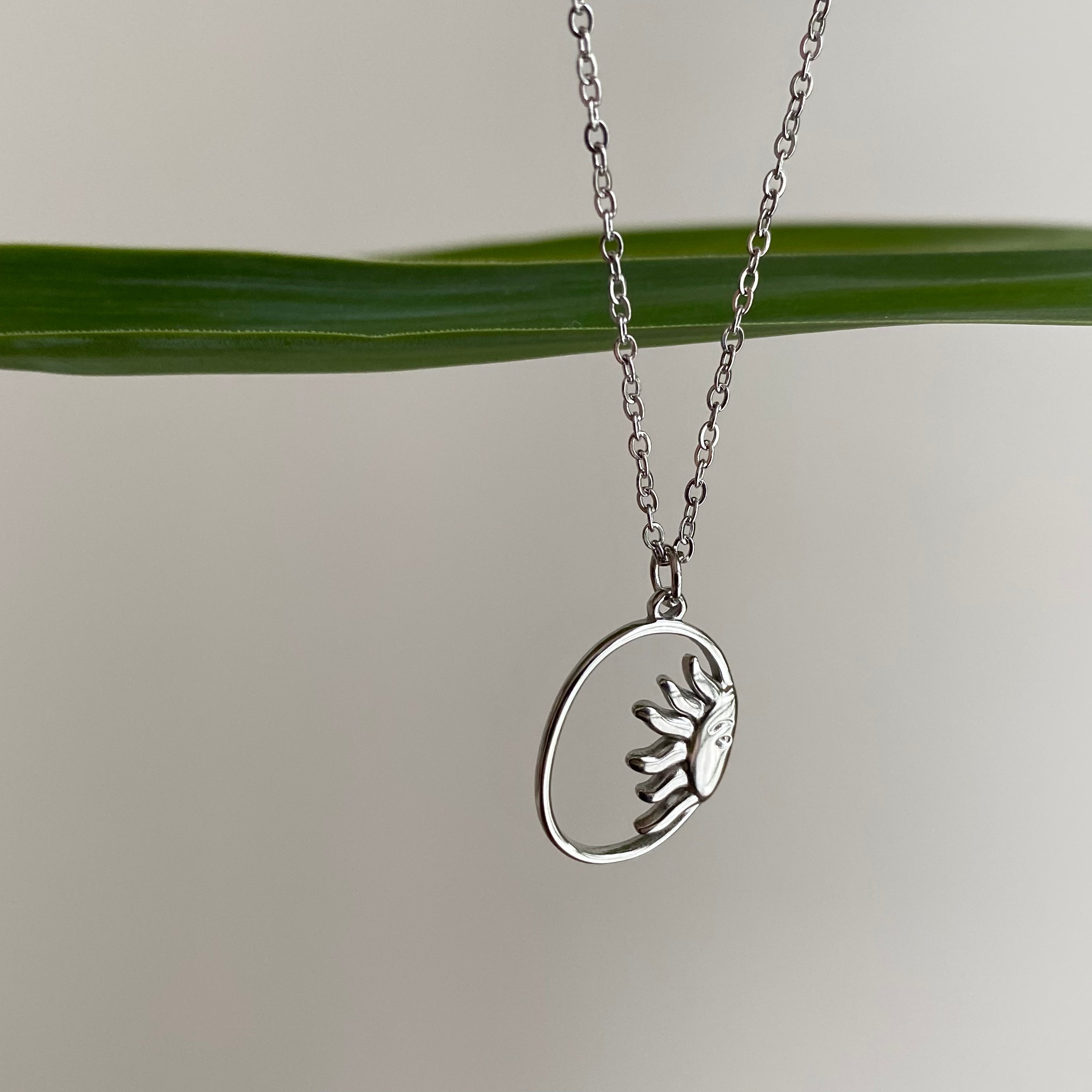 Silver Peaking Sun in Oval Pendant Necklace